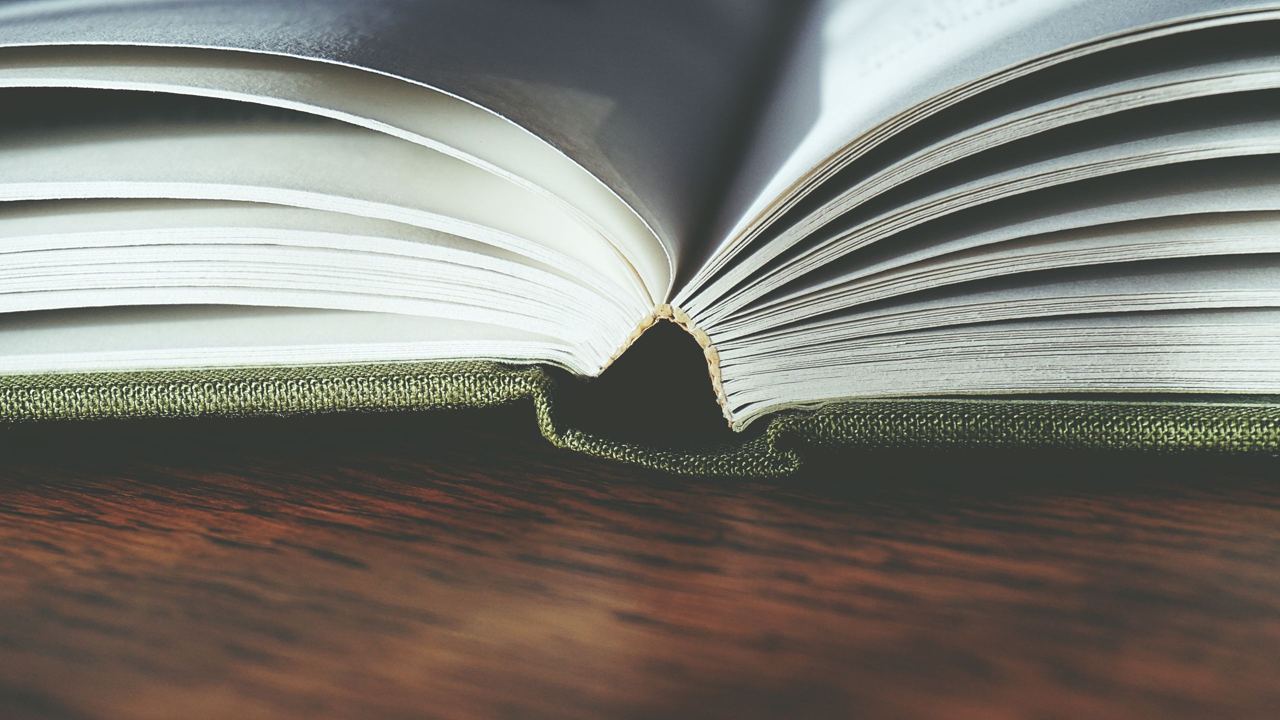 Open book on wooden table